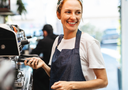 Barista at coffee shop smiling