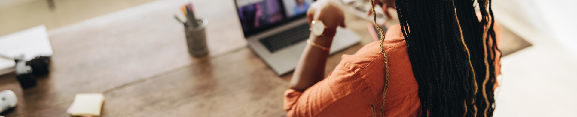 A woman in a virtual meeting on her computer.