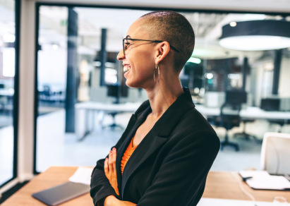 woman in office looking out window 