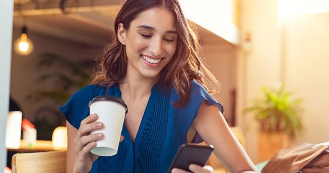 Woman in blue dress with cup of cofee