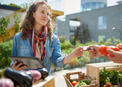 smiling woman buying produce