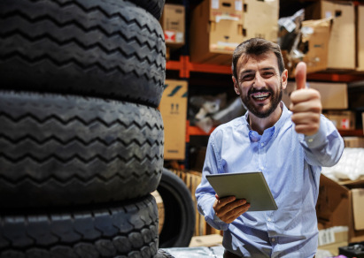 Tire shop owner giving thumbs up 