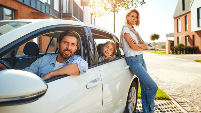 Family showing off new car 