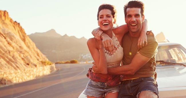 Couple hugging on side of the road 