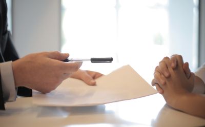 Two people going over terms on a contract.